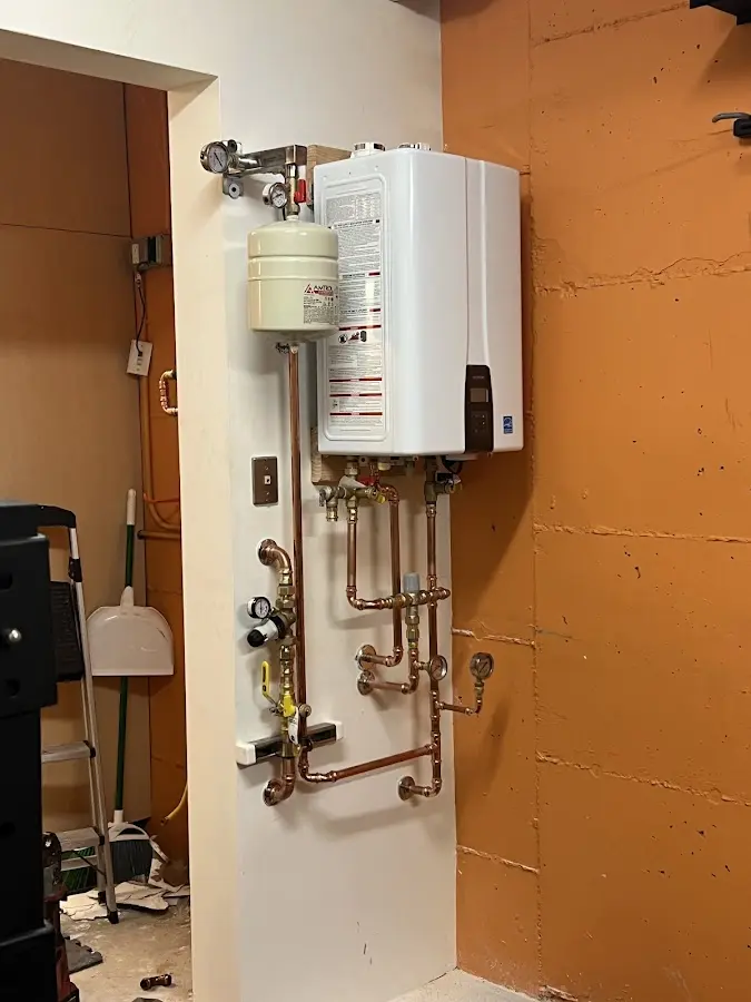 Plumbing technician inspecting water heater connections in Bay St. Louis